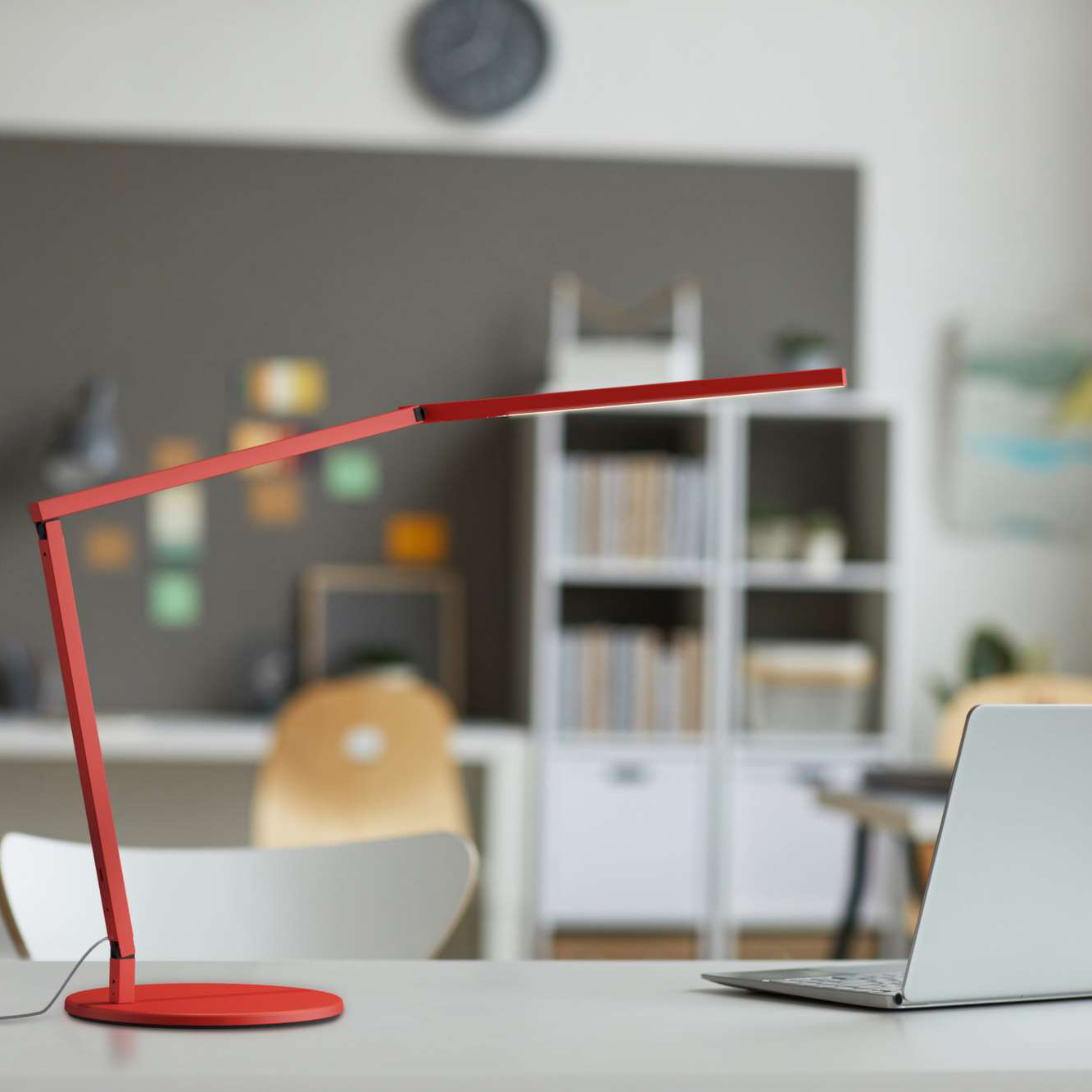 Koncept Z-Bar Desk Light in red finish on desk – modern LED reading lamp in workspace