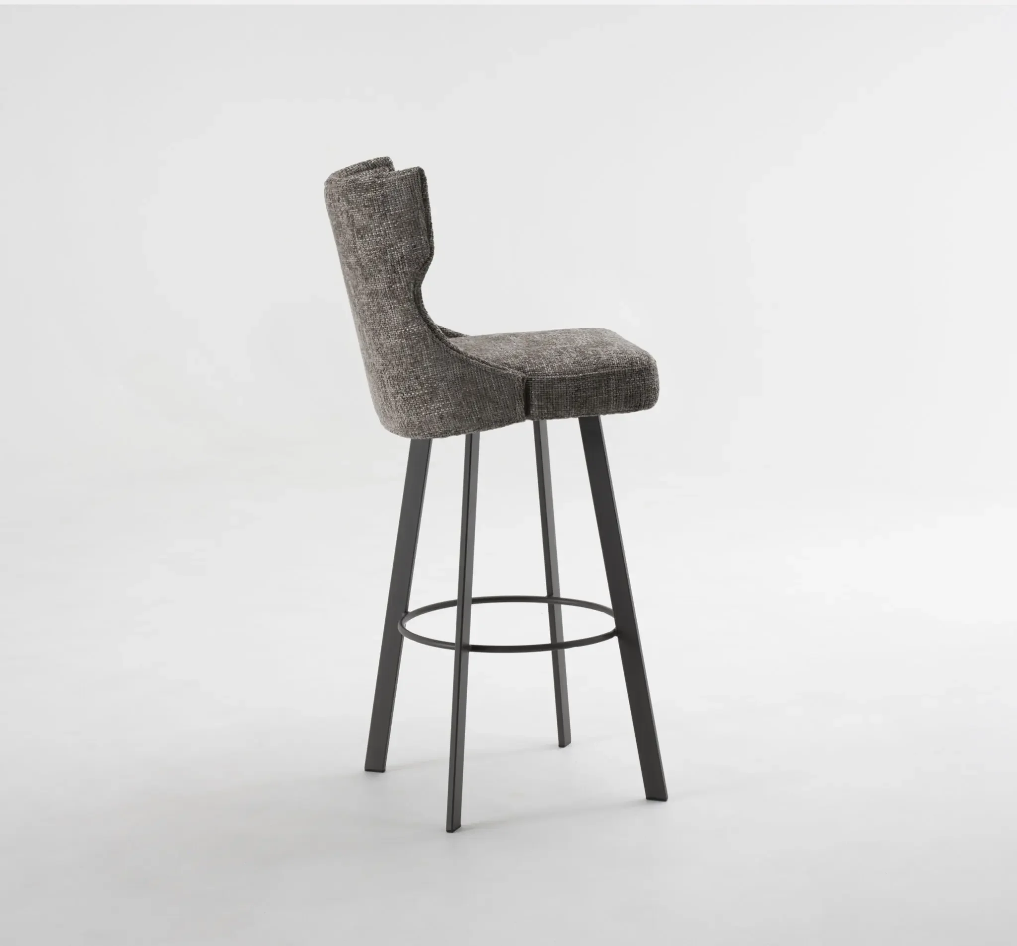 Side view of Trica Luna Swivel Stool with dark grey upholstered seat and black frame