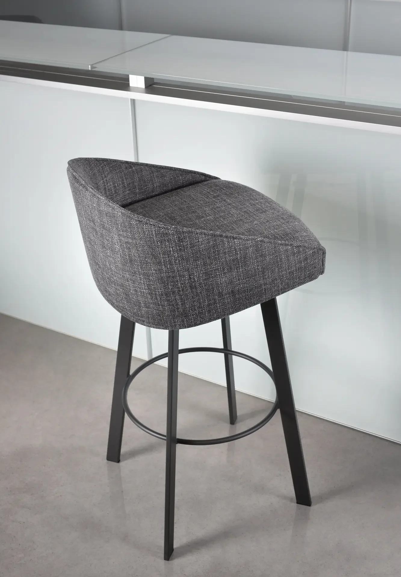 Grey upholstered Trica Liv Counter Stool tucked under modern kitchen counter