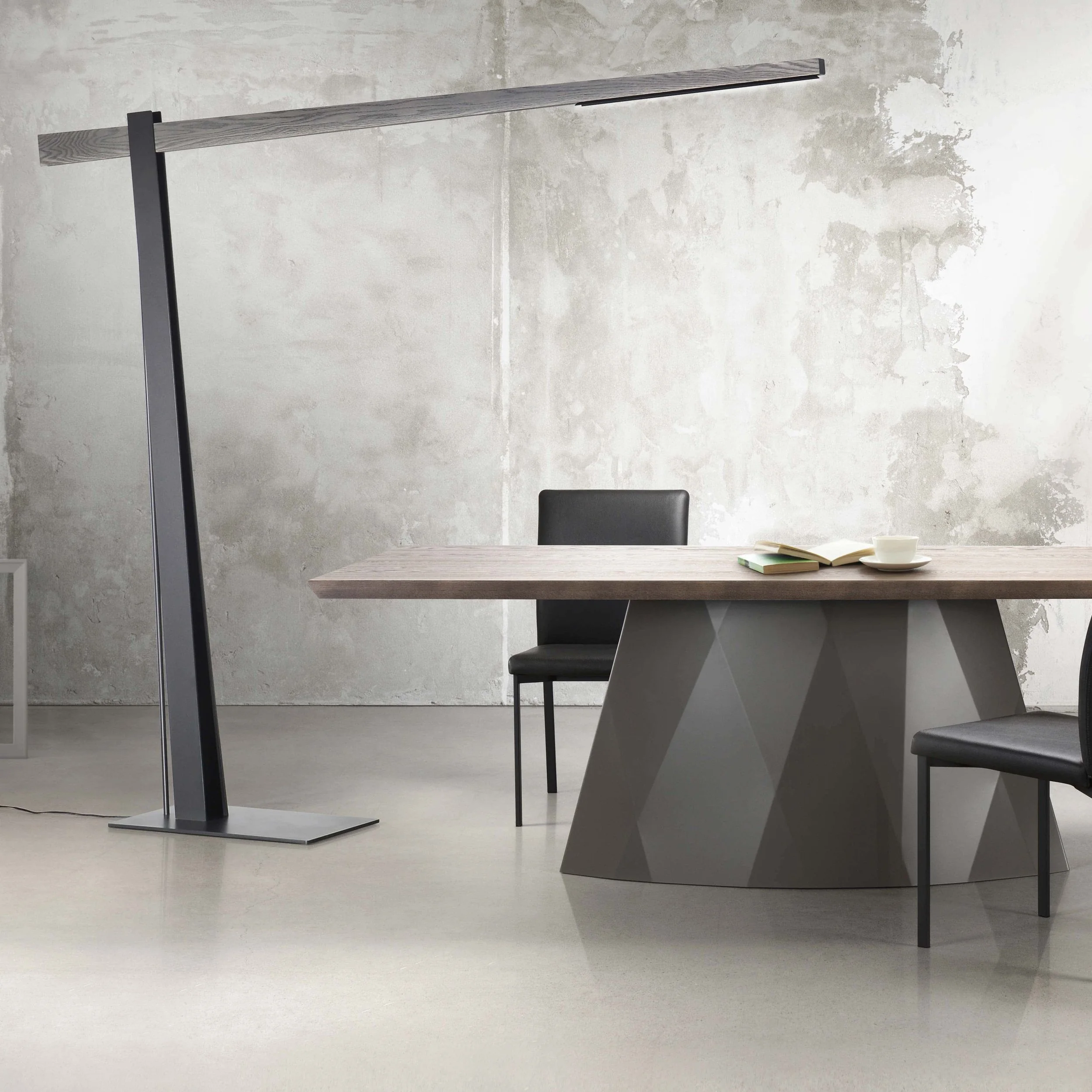 Black Trica Beam Lamp with wood accent arm placed beside modern dining table