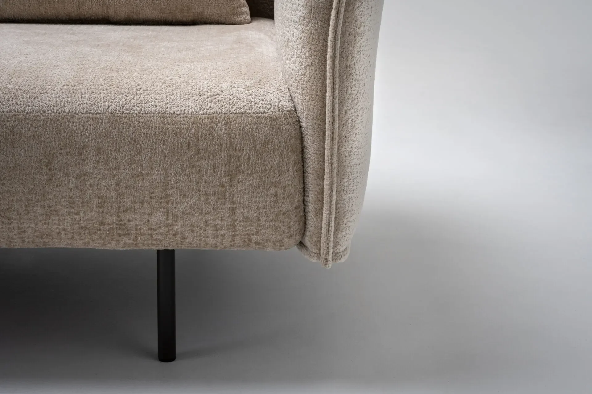 Detail view of sofa arm and metal leg on Trica Le Beaumont Sofa