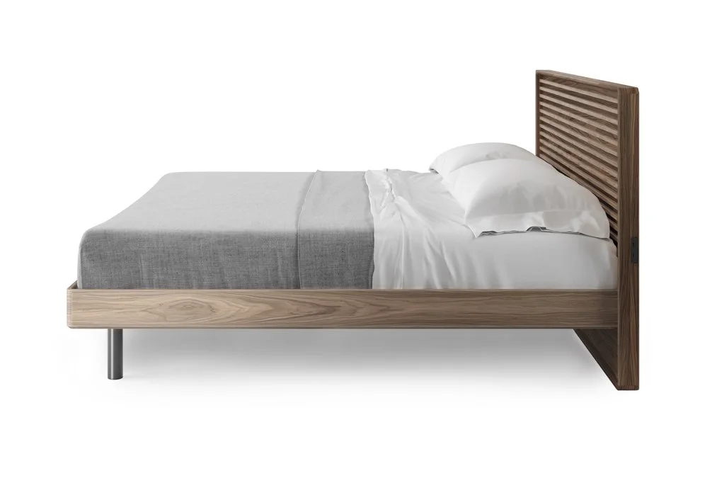 Side profile of Cross-LINQ bed featuring low-profile frame and sculpted walnut slat headboard