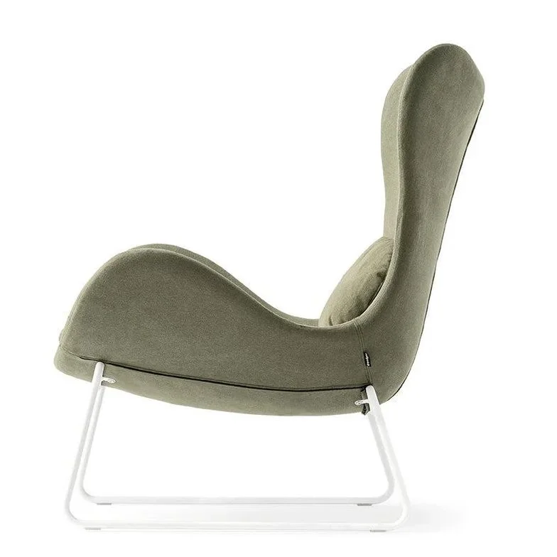 Side view of Lazy Chair in sage green fabric with curved backrest