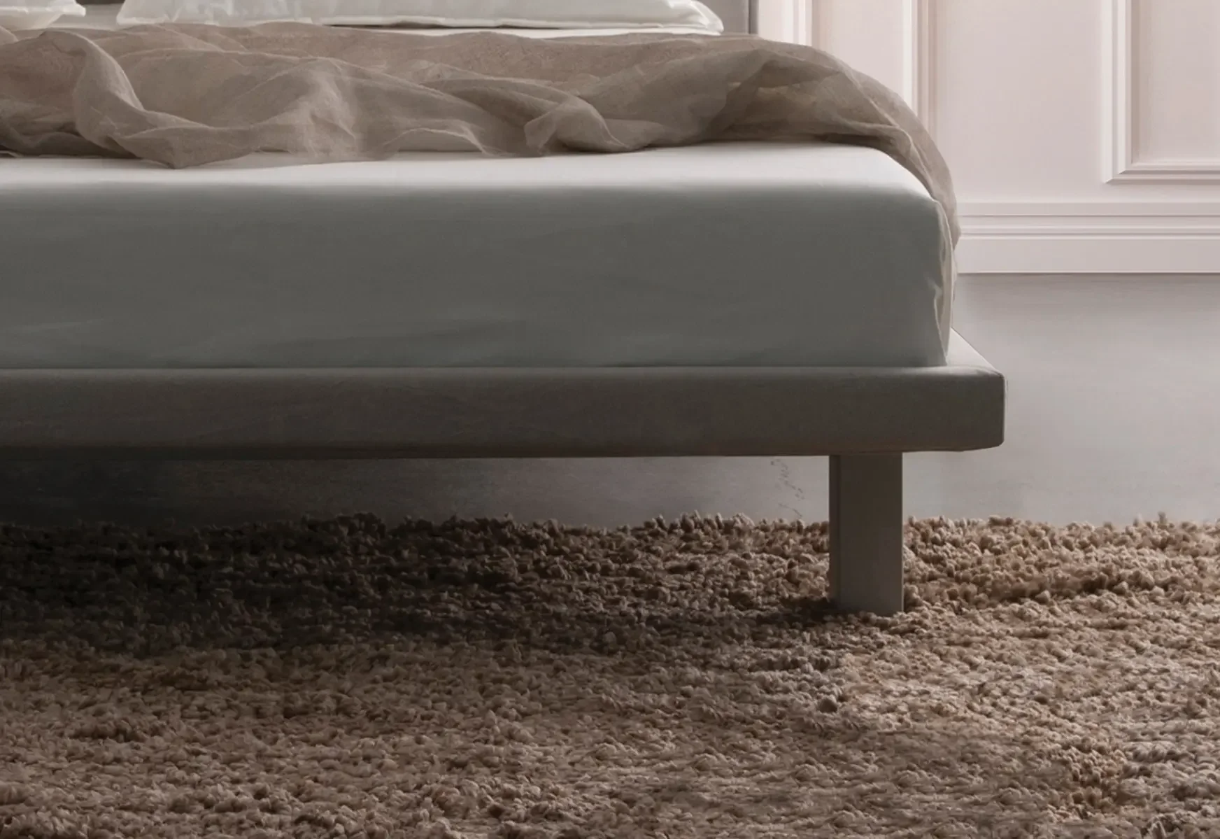 Side view of Trica Envy Bed with light upholstery in modern bedroom setting