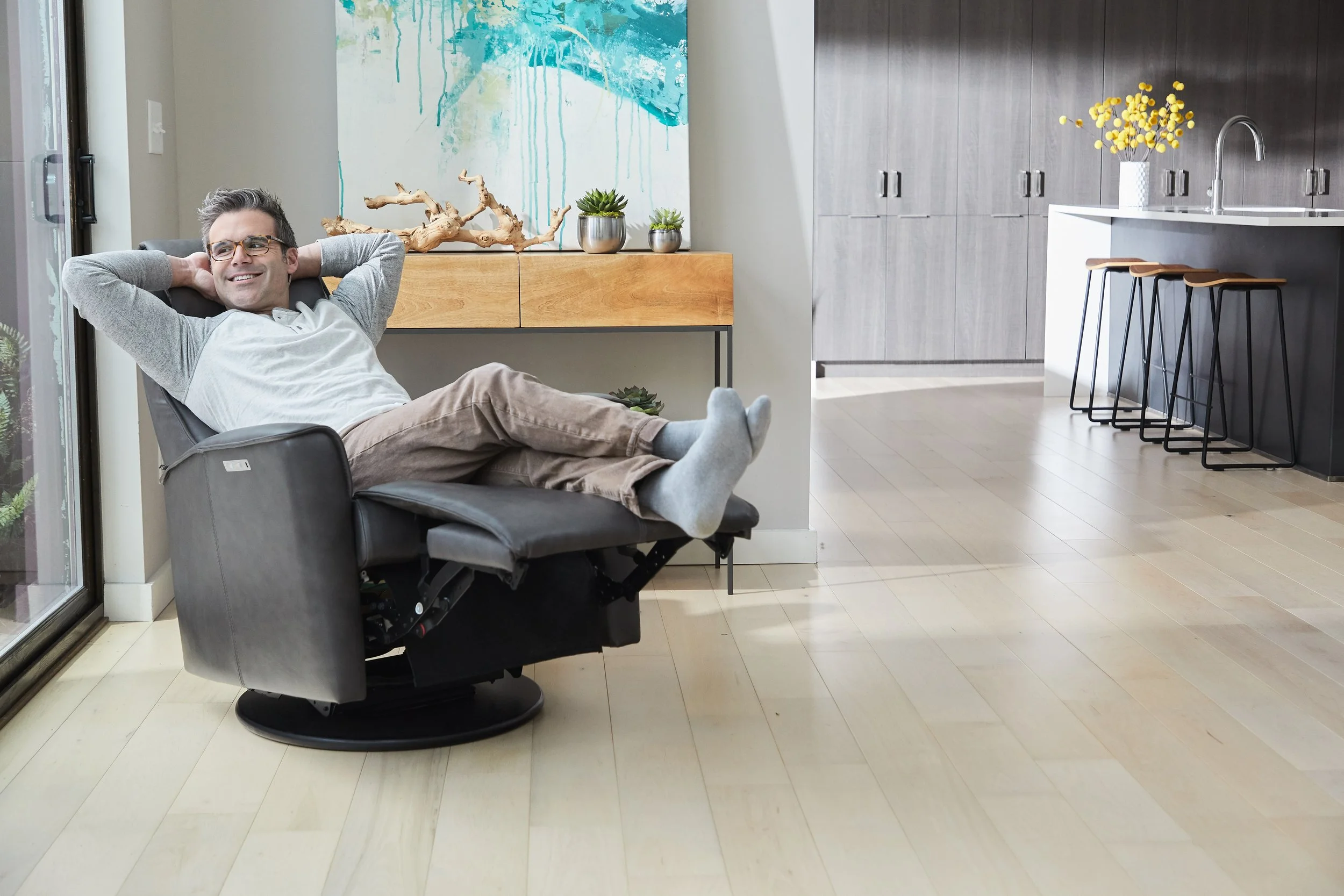 Man relaxing in Fjords Urban Recliner in a modern living room