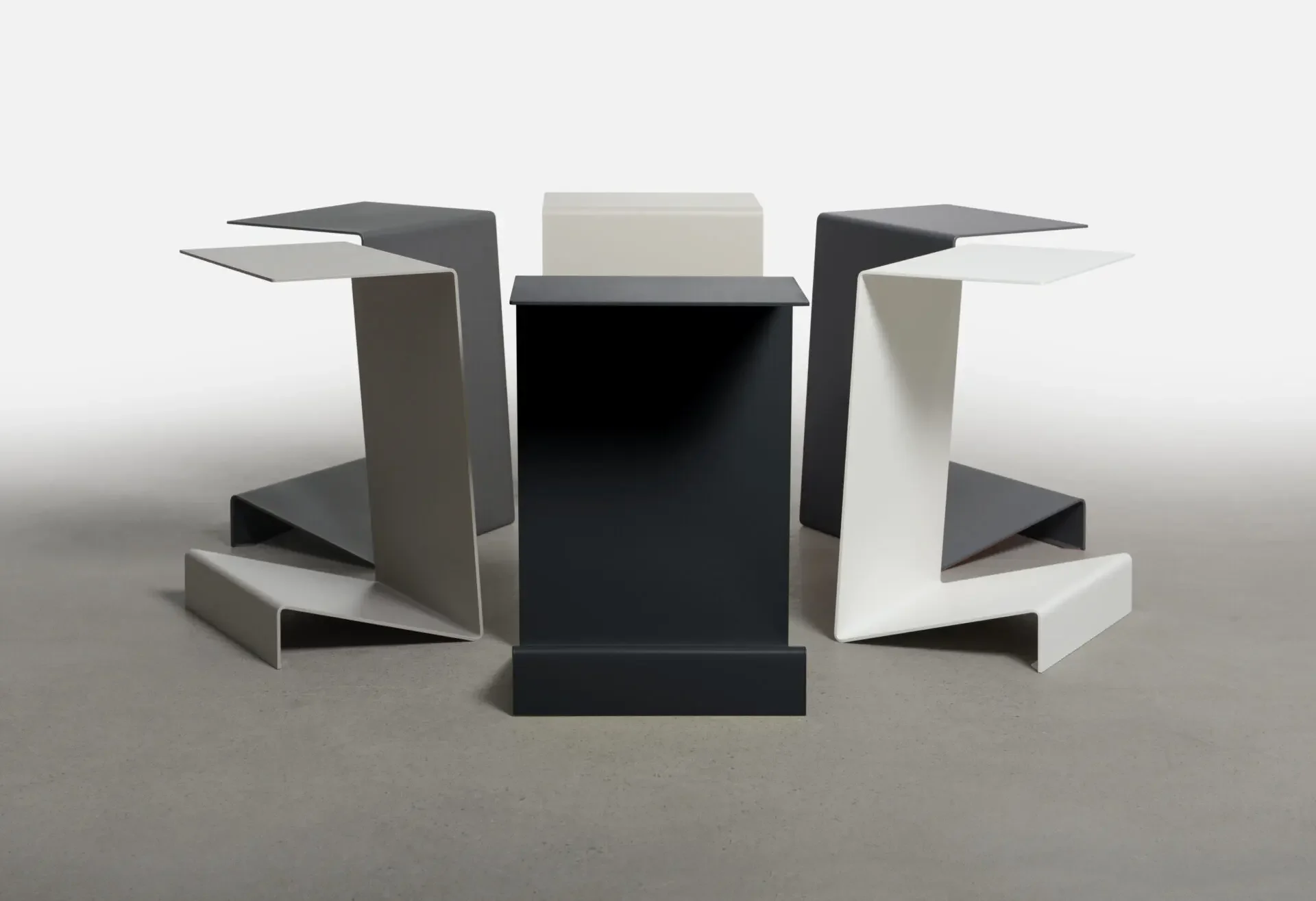 Collection of Zigzag End Tables in assorted colors including black, grey, and cream