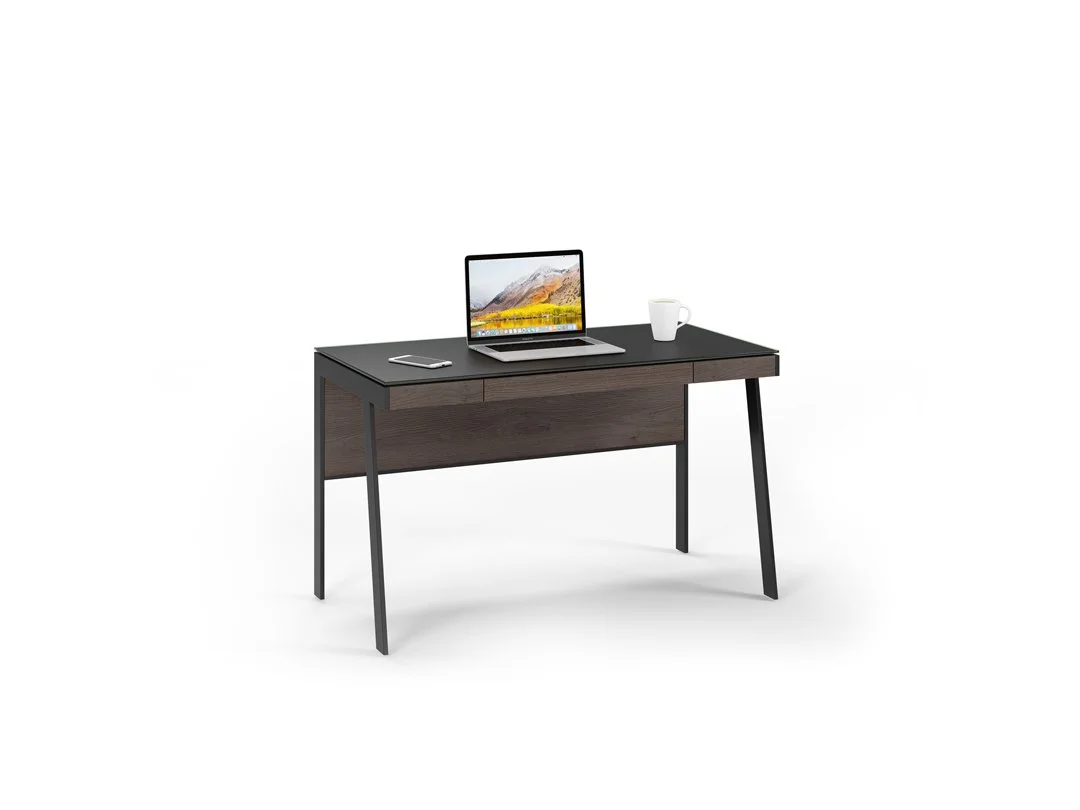 Sigma Compact Desk with laptop, mug, and accessories, showcasing compact workspace setup