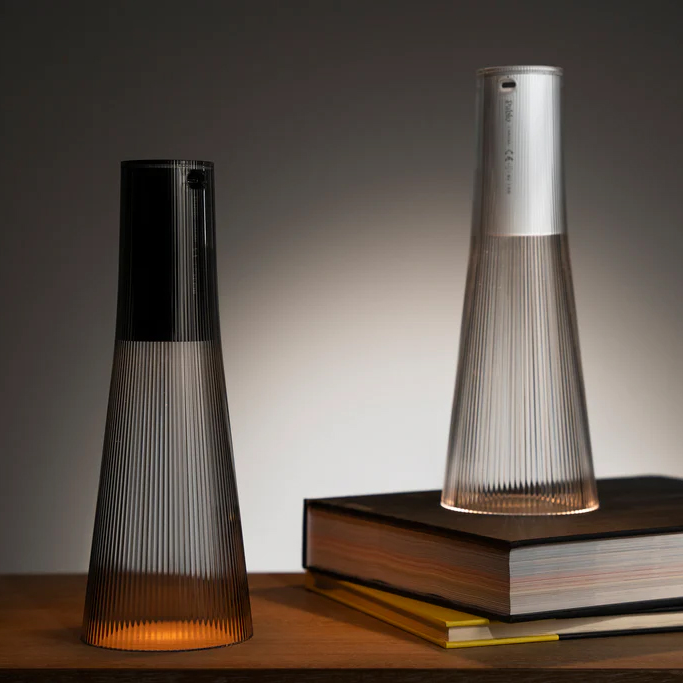 Pablo Candel Table Lamp in smoked glass finish, placed on books