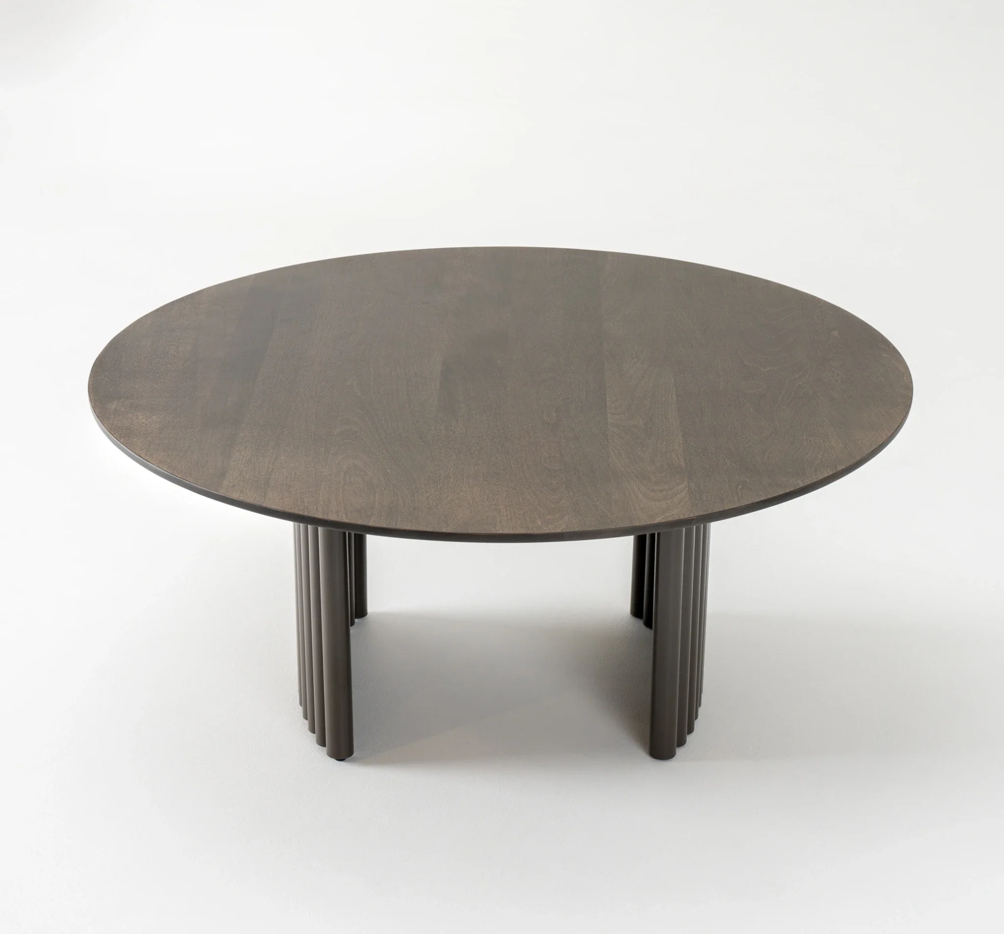 Front view of Trica Cove Cocktail Table showcasing round top and fluted base
