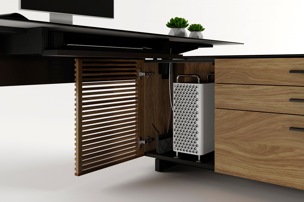 Close-up of computer tower compartment with slatted door open in natural walnut Corridor L-Desk