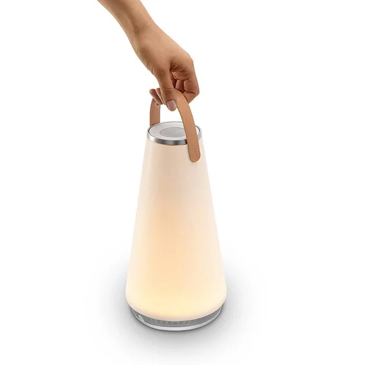 Hand carrying Pablo Uma Lantern with warm LED glow