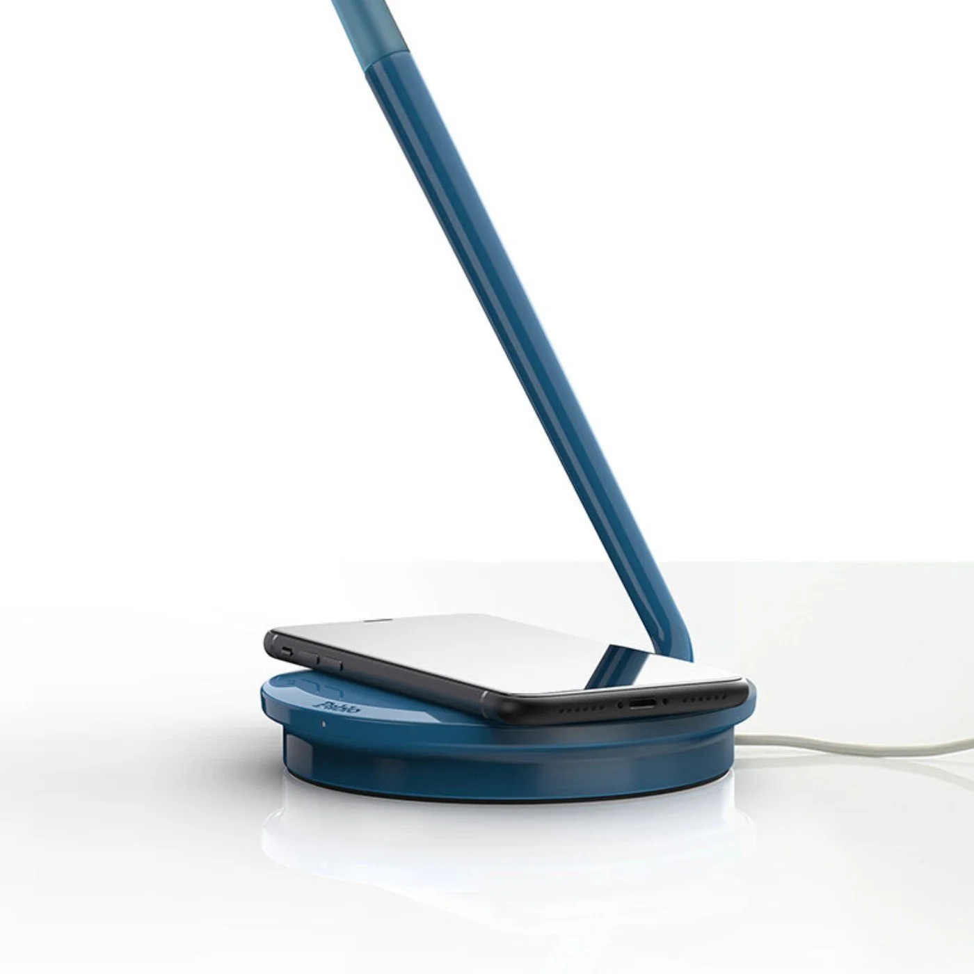 Close-up of Pixo Plus base charging a smartphone via Qi wireless pad