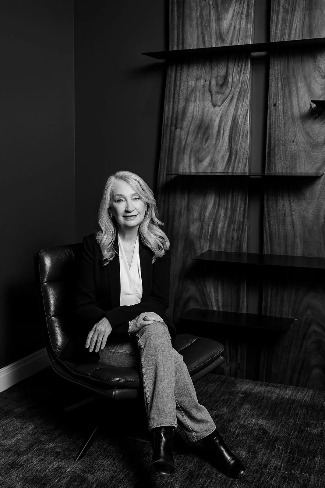 Person sitting on a couch in a brightly colored room with abstract artwork on the wall.