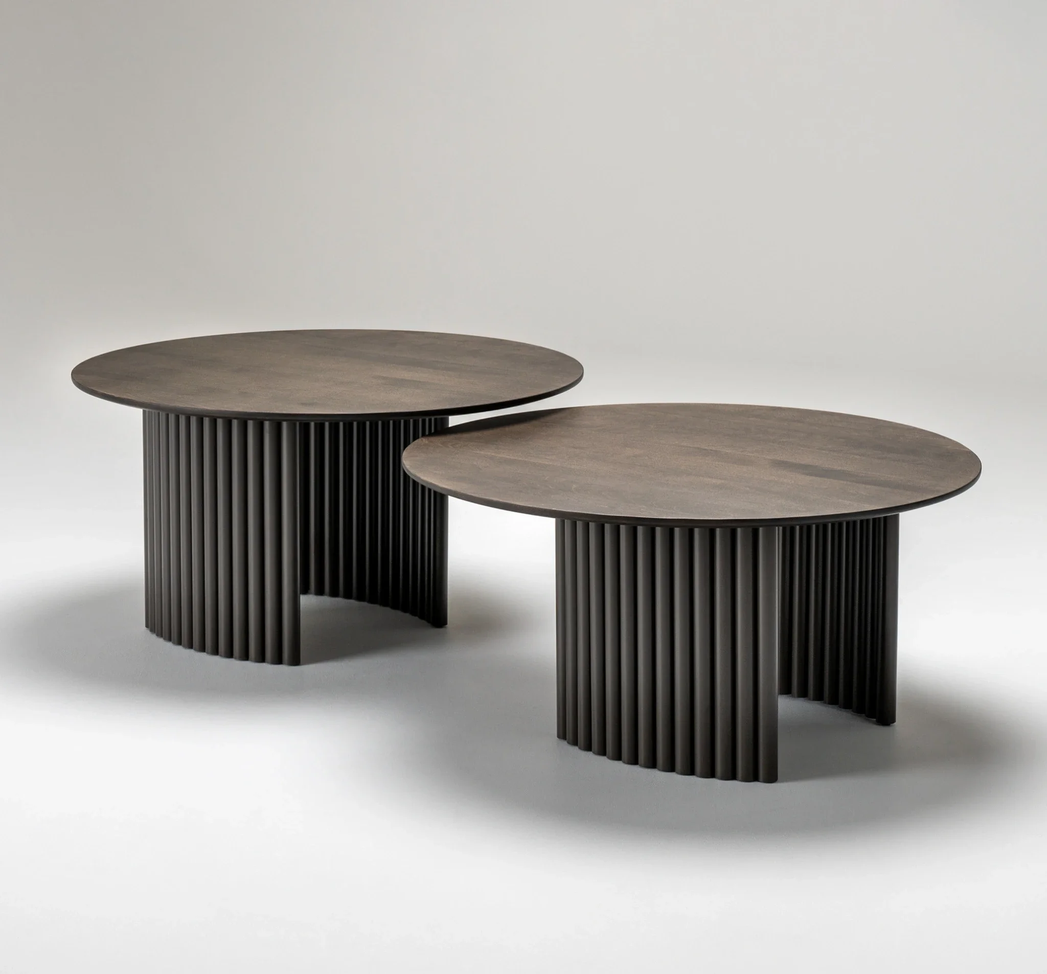 Two Trica Cove Cocktail Tables in different sizes with matching wood tops and fluted bases