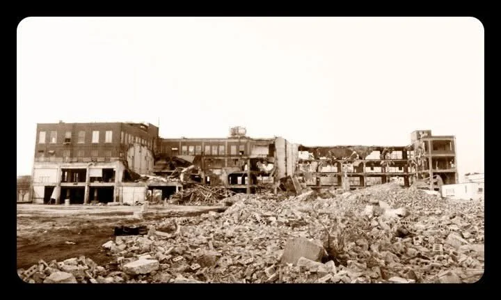 Destroyed building with debris and rubble in the foreground.