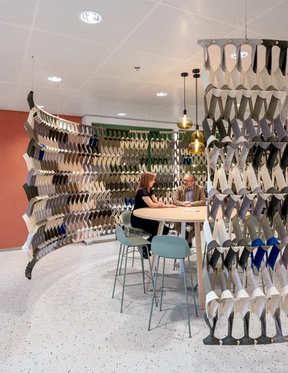 Woven felt detail and clay-textured wall in The Garden Room at Rabobank Headquarters, Utrecht, designed by Meeder Ontwerpers.