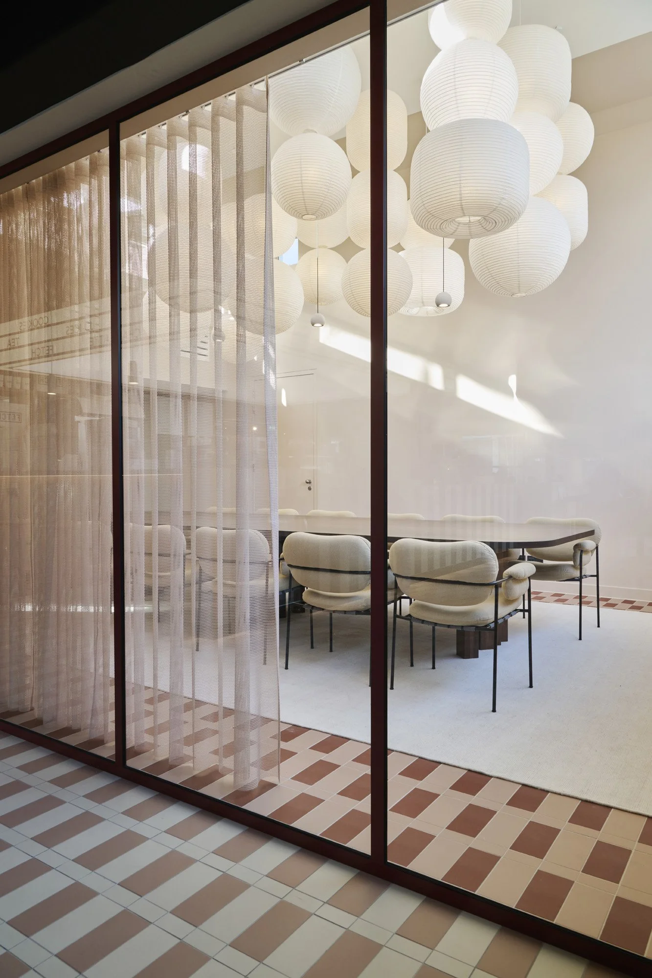 KBF Warehouse meeting room featuring oversized pendant lighting and pink curtains, Amsterdam.