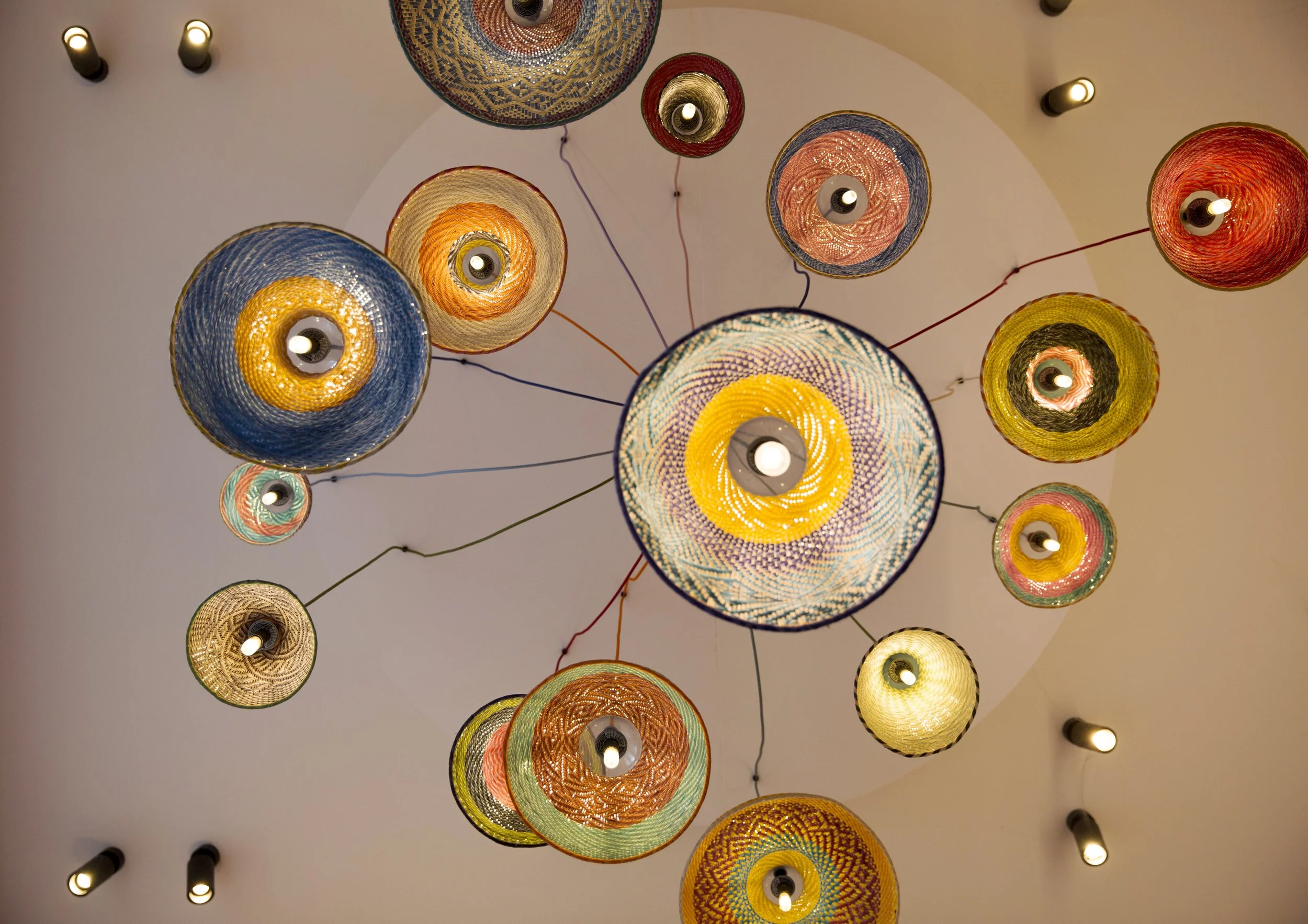 Coloured pendant lamps above dining area at Restaurant Nazka, Amsterdam. Designed by Meeder Ontwerpers