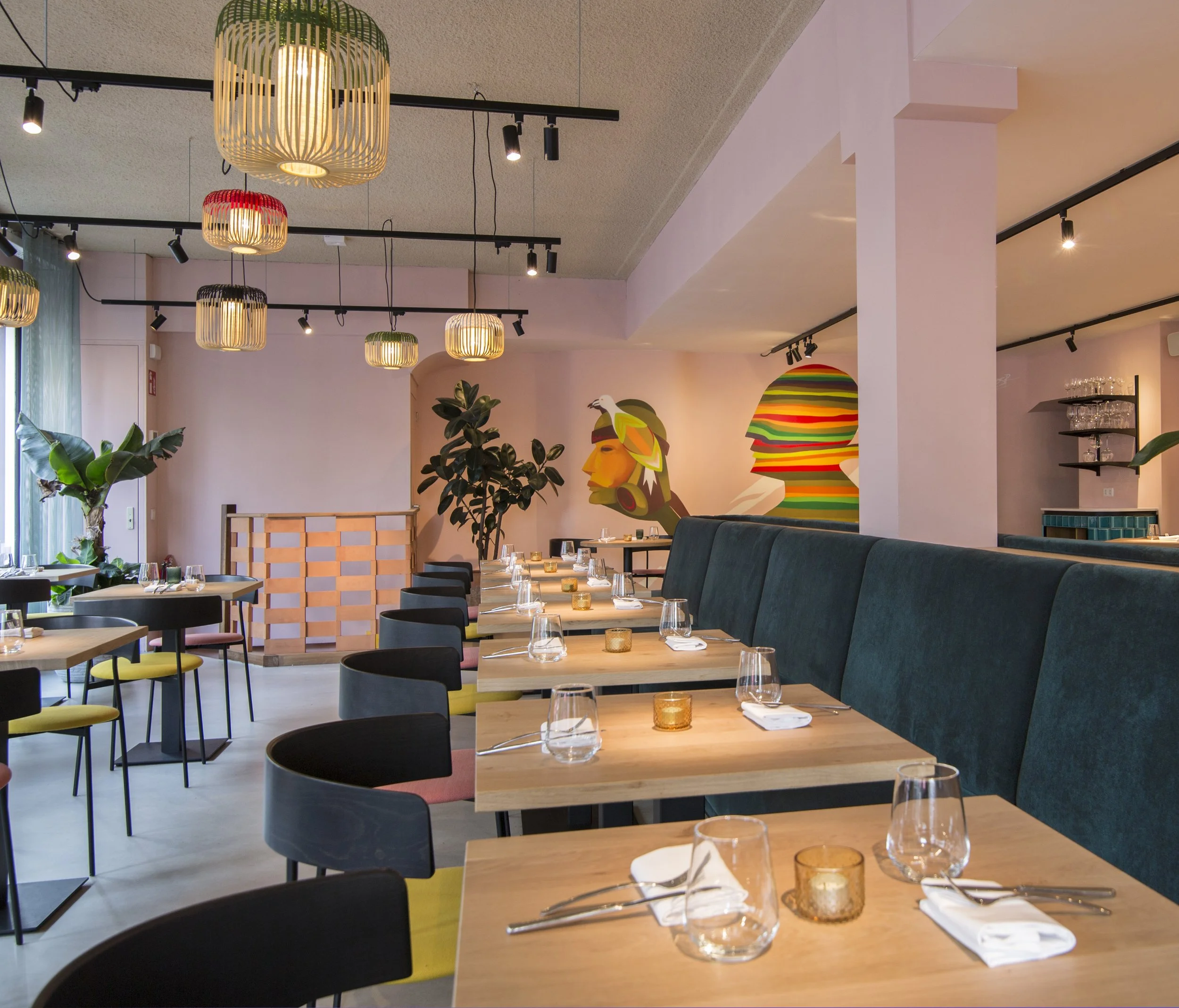 Blue velvet banquette with pink wall and mural at Restaurant Nazka, Amsterdam, designed by Meeder Ontwerpers.