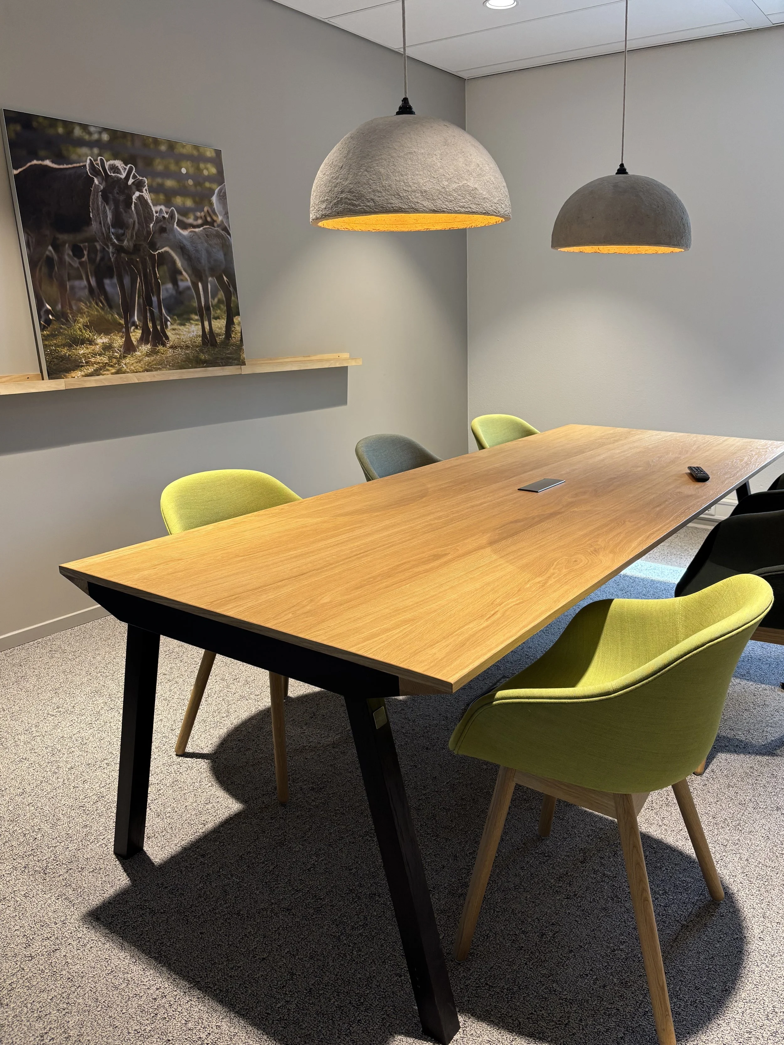 Green chairs with paper pendant lamps at Northbound Travel office, Naarden, designed by Meeder Ontwerpers.
