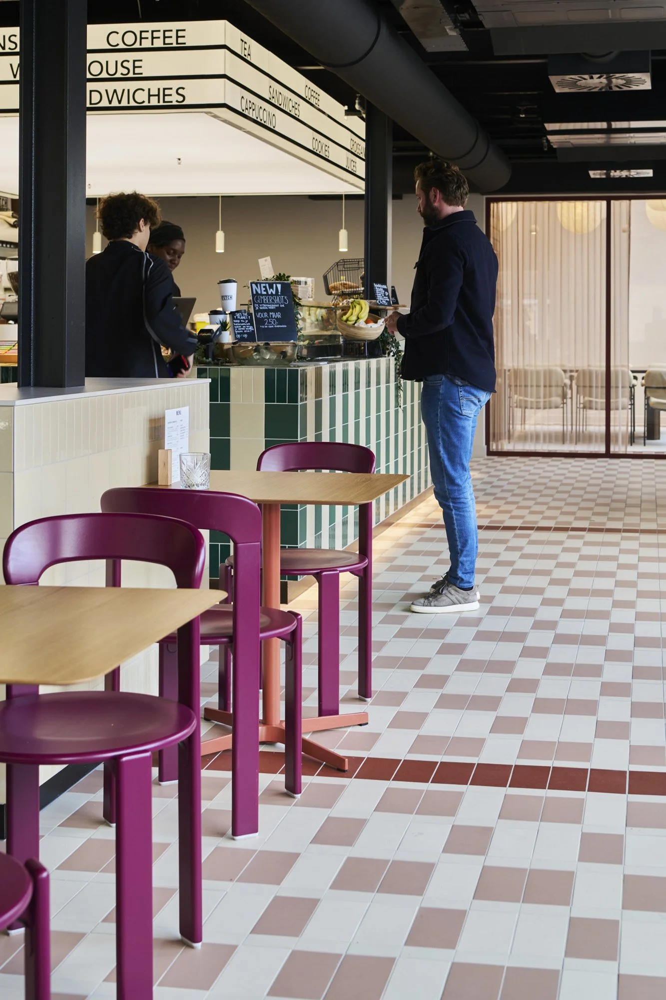 Deli counter with Rey chairs and illuminated lightbox at KBF Warehouse, Amsterdam.