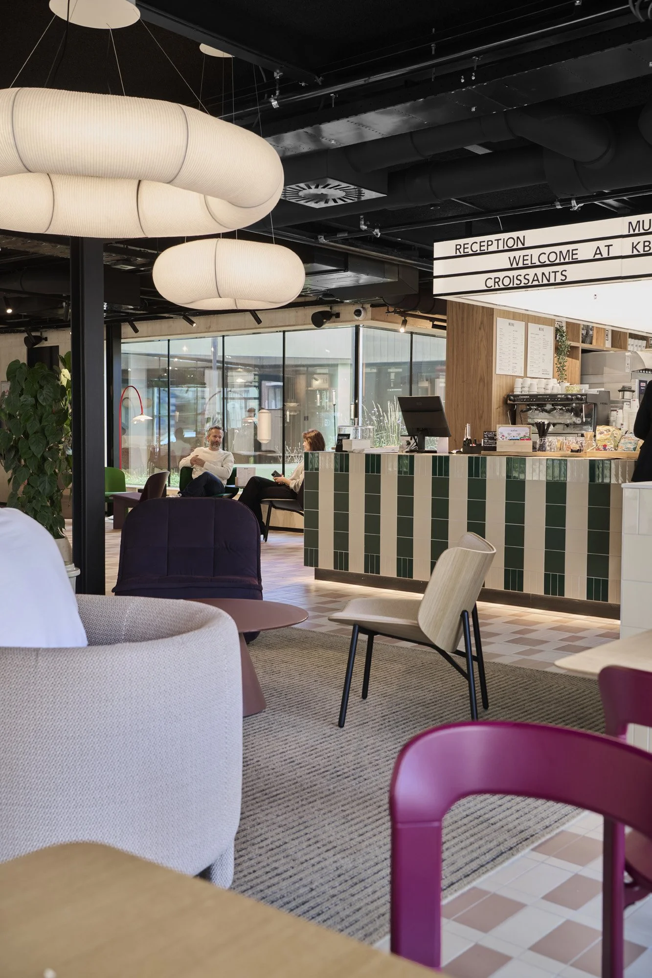 Cosy seating with counter and pendant lamps at KBF Warehouse café designed by Meeder Ontwerpers