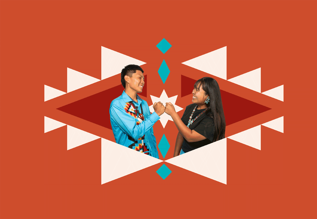 Two people smiling and engaging in a fist bump against a geometric patterned background with red, white, and blue elements.