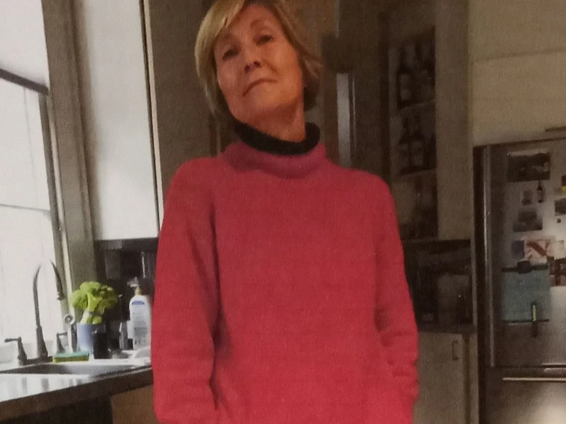 The photo is of Whitney Stewart standing in her kitchen. She is modeling the pants on which she ironed her script "Steal the Light.  She was inspired to think out of the box after Pamela Eveline's InVision hypnotic sessions.