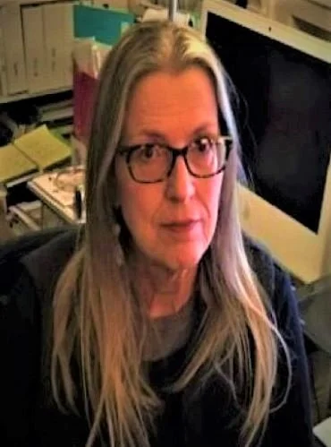 This image is a photograph of Sharon Jacques sitting next to her computer. here she types her imaginative and inspiring poetry. Sharon became a Reiki Master to receive illuminations and to enlighten the world with her gifts.