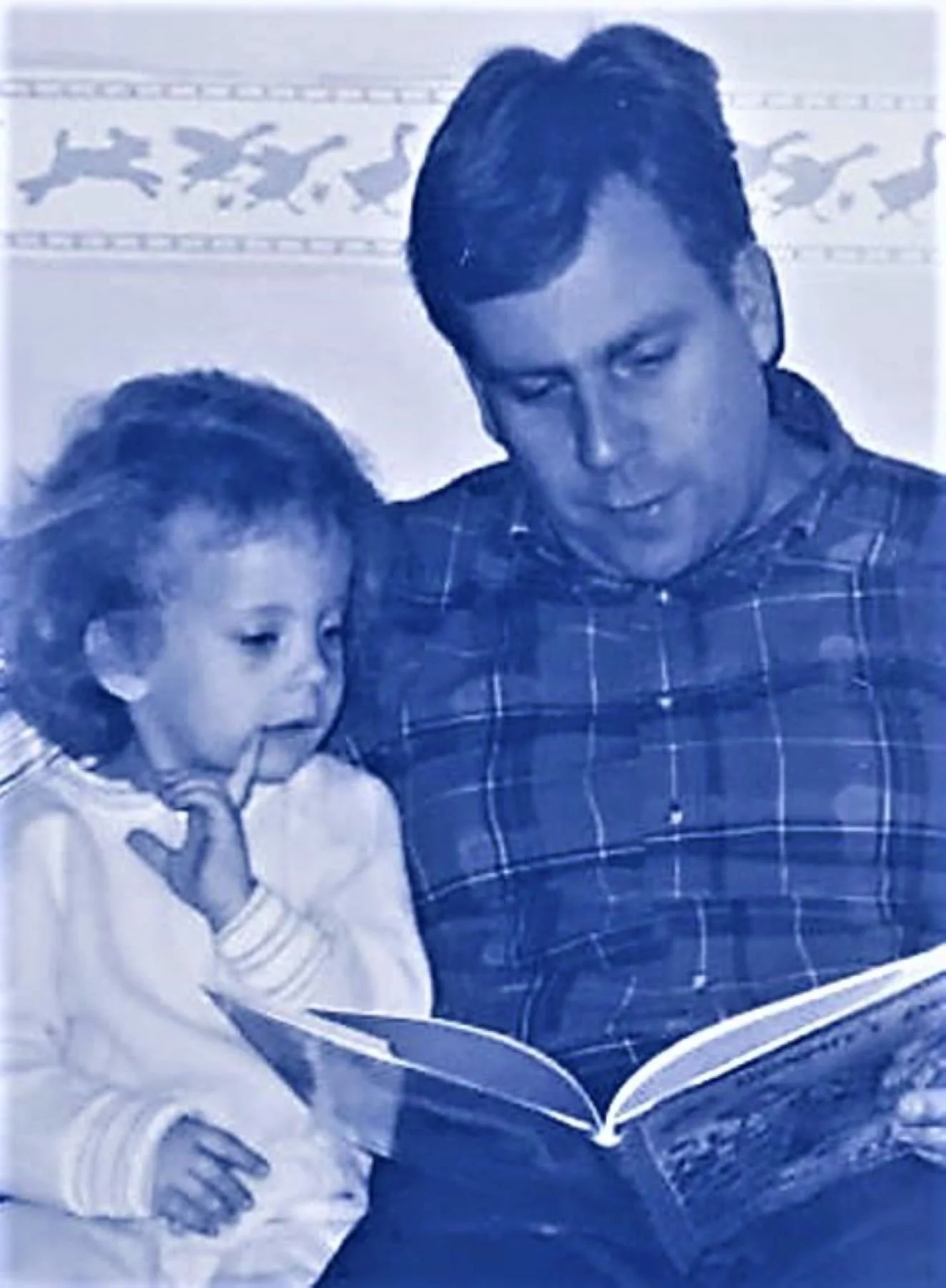 This is an image of Mark Kelly reading his daughter a story. This photo illustrates an essay he wrote after experiencing one of Pamela Eveline's guided imagery shamanic journey while in a group workshop.