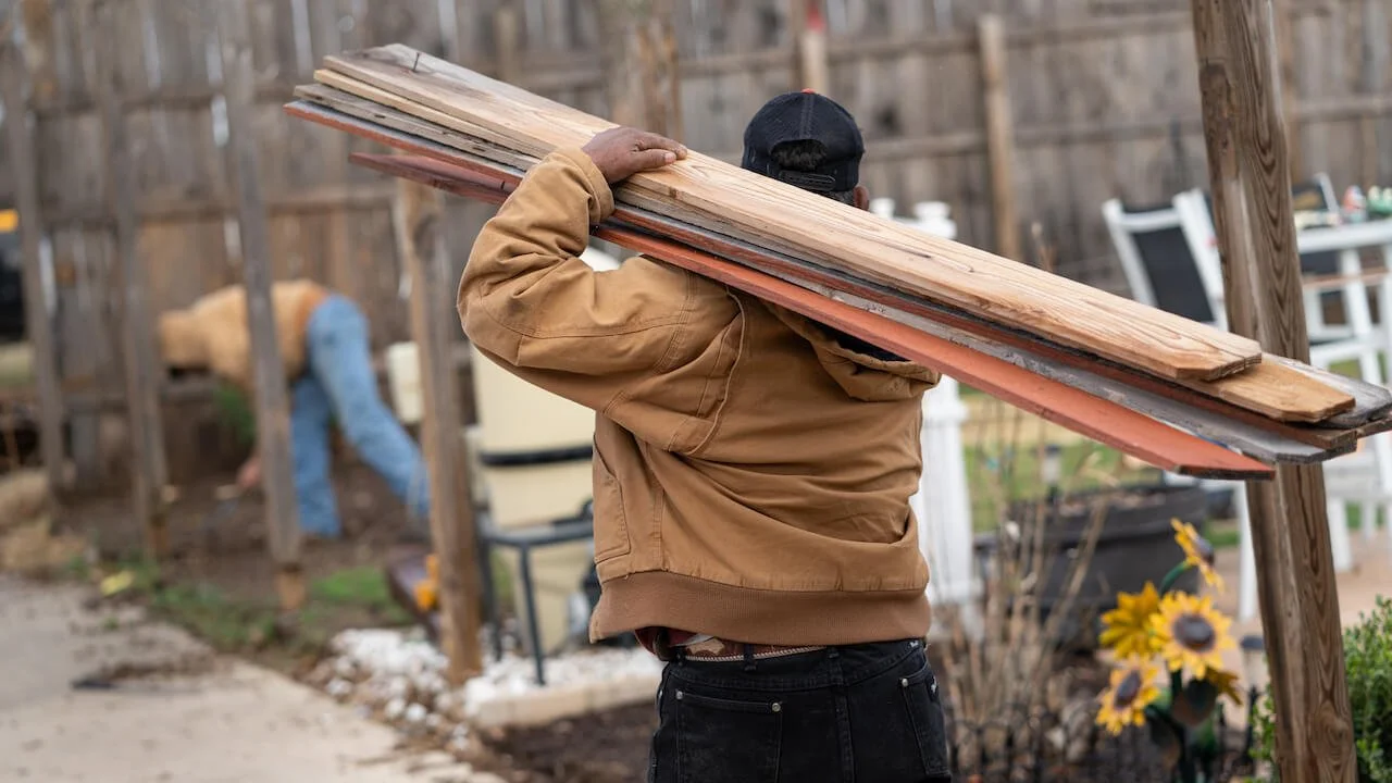 Fencing business owners discussing a commercial fence project before selling their company