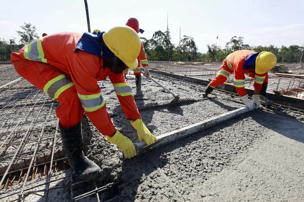 Construction business brokers reviewing a commercial jobsite before a company sale