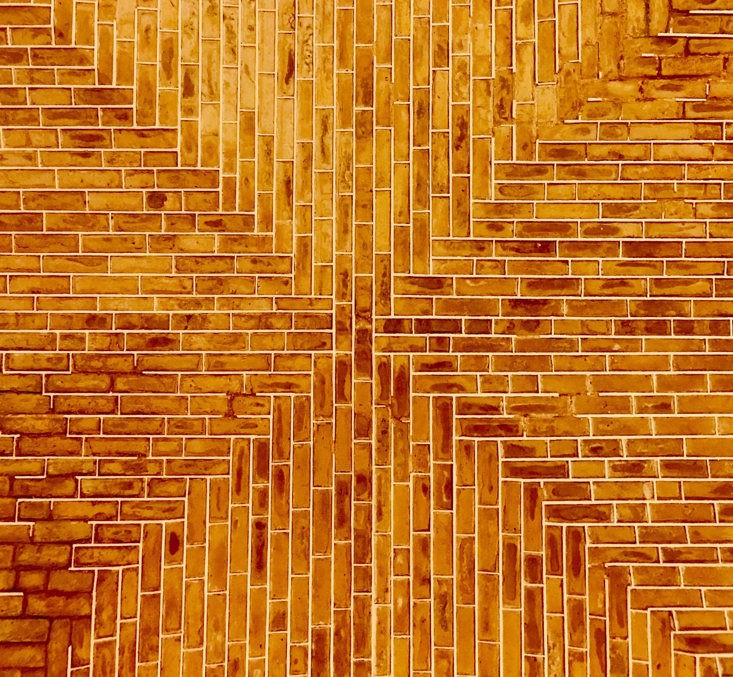 Patterned brown brick wall with intricate geometric design