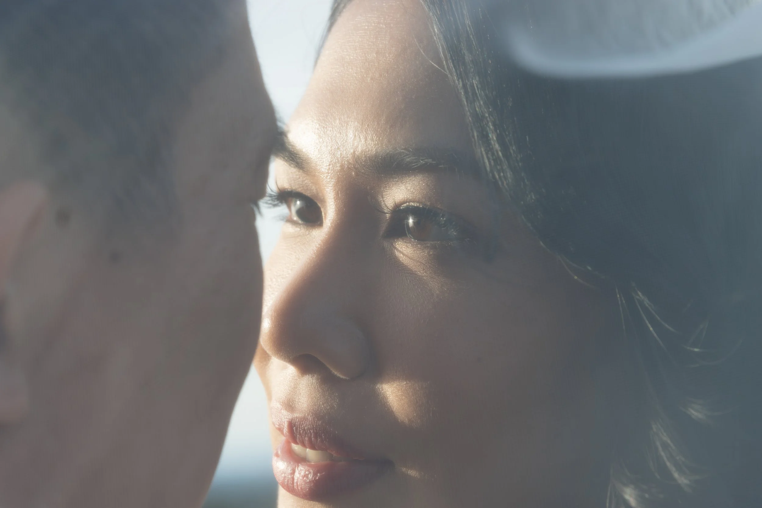 Close-up of two people face to face, with the focus on their eyes and noses, creating an intimate moment. Under the veil photos. Oregon Wedding photographer
