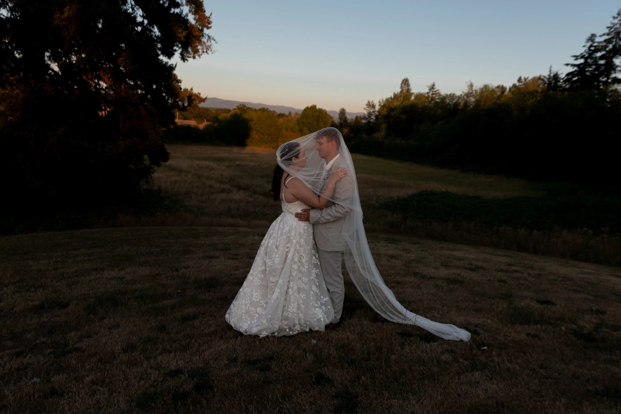 A bride and groom dressed in wedding attire sharing a romantic moment outdoors. Golden hour wedding portraits, Oregon wedding photographer, Bay Area Wedding, California Wedding, Best wedding photographer, Portland Wedding, Wedding photography