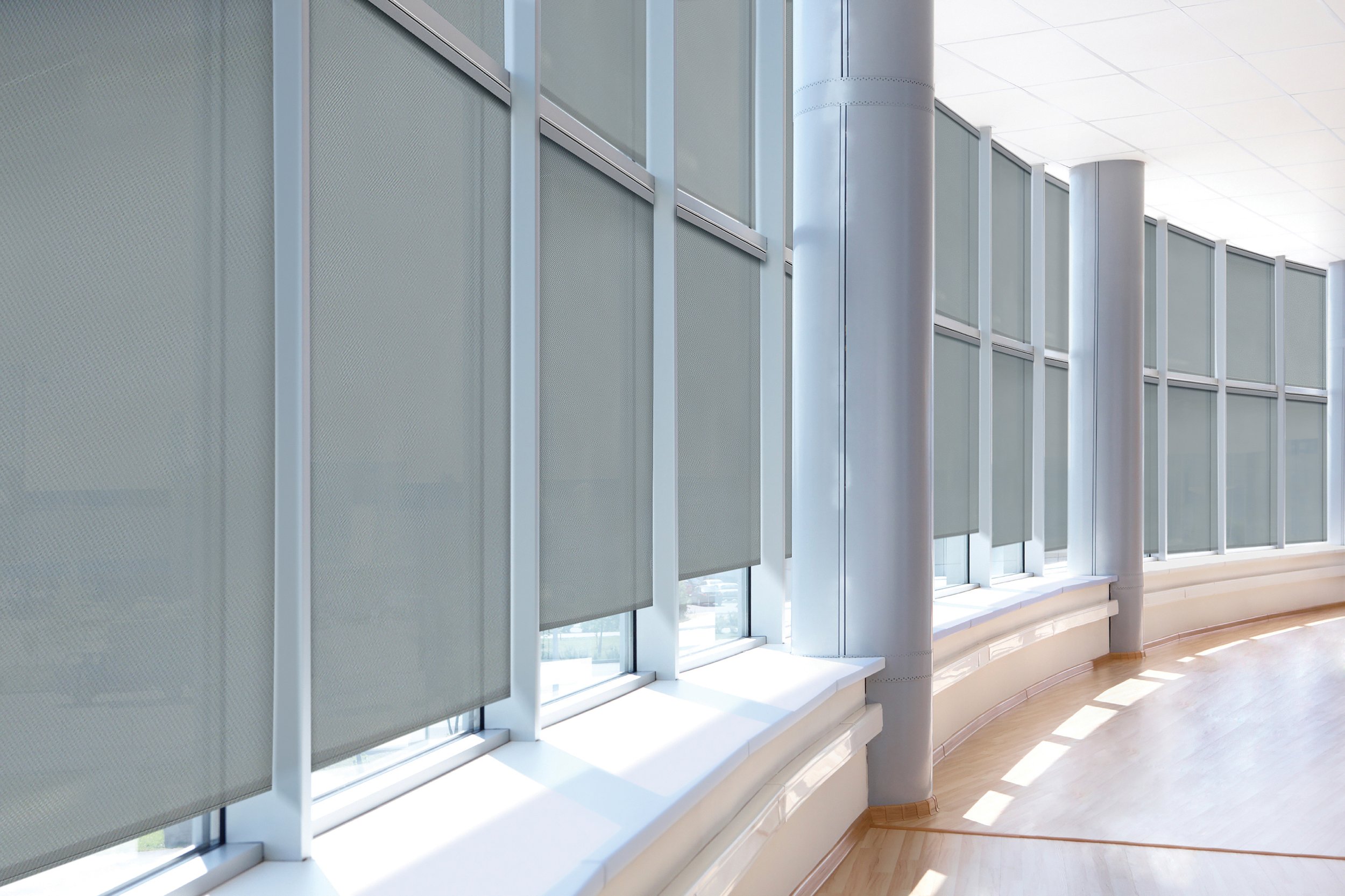 large windows with roller blinds in a modern building interior