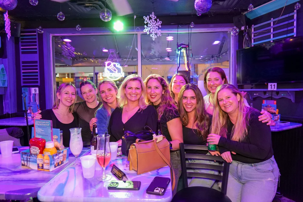 Friends gathered around a table at Freddie’s Beach Bar in Rehoboth