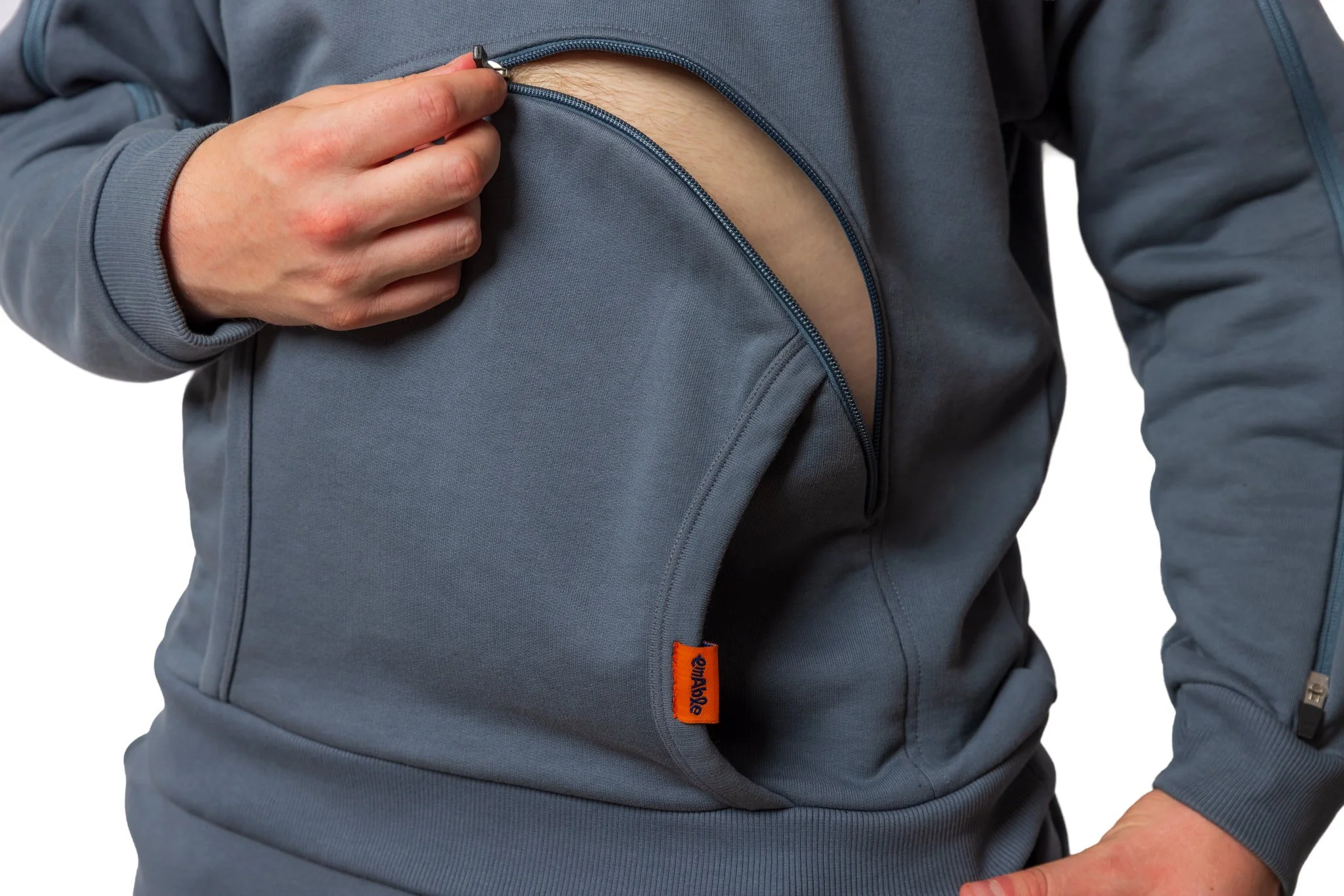 Hooded top with easy accessible zips, incluidng a lower torso opening, to avoid having to lift or remove clothing.