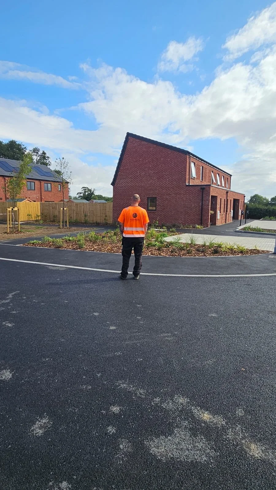 Perennial Landscapes van  with a suporvisor in the background working machinery to lift a pallet