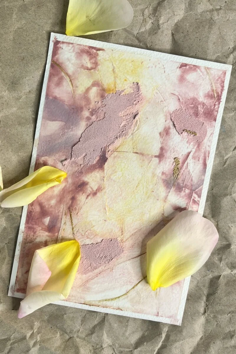 Delicate mixed-media artwork in soft pink and yellow tones with rose petals — part of the ‘Held by Myself’ series exploring self-love and acceptance.