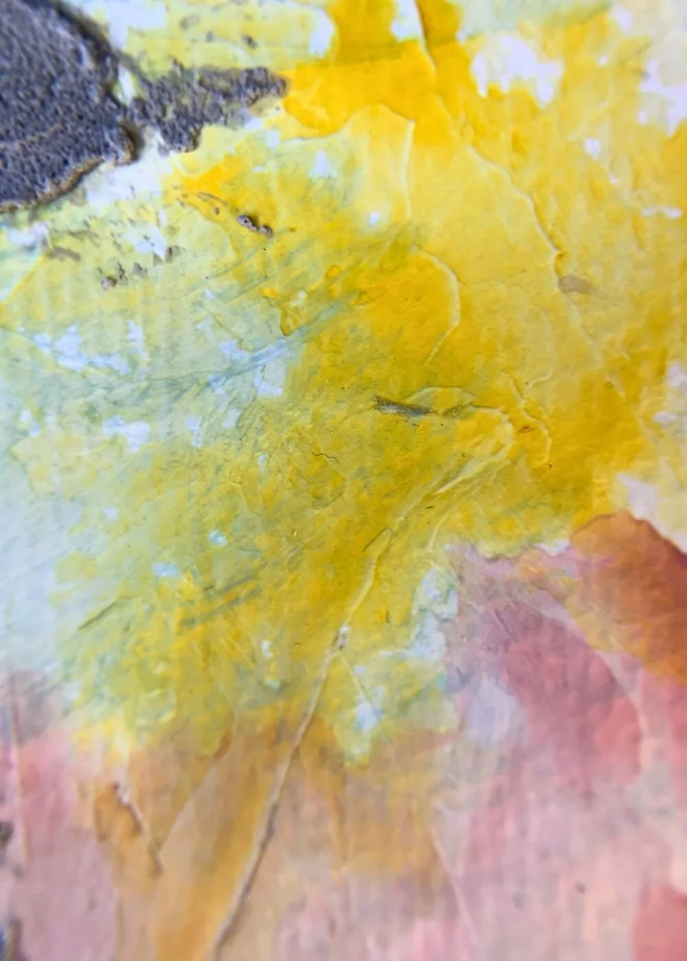 Macro detail of the artwork "Between the Seconds No. 6" highlighting layered yellow paint with textured surfaces and subtle undertones of pink.