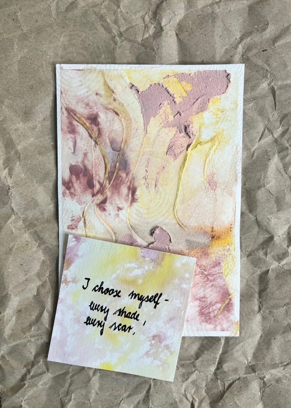 Postcard-sized mindfulness artwork “Held by Myself No. 3” resting on kraft paper, accompanied by an affirmation card affirming self-love and presence.