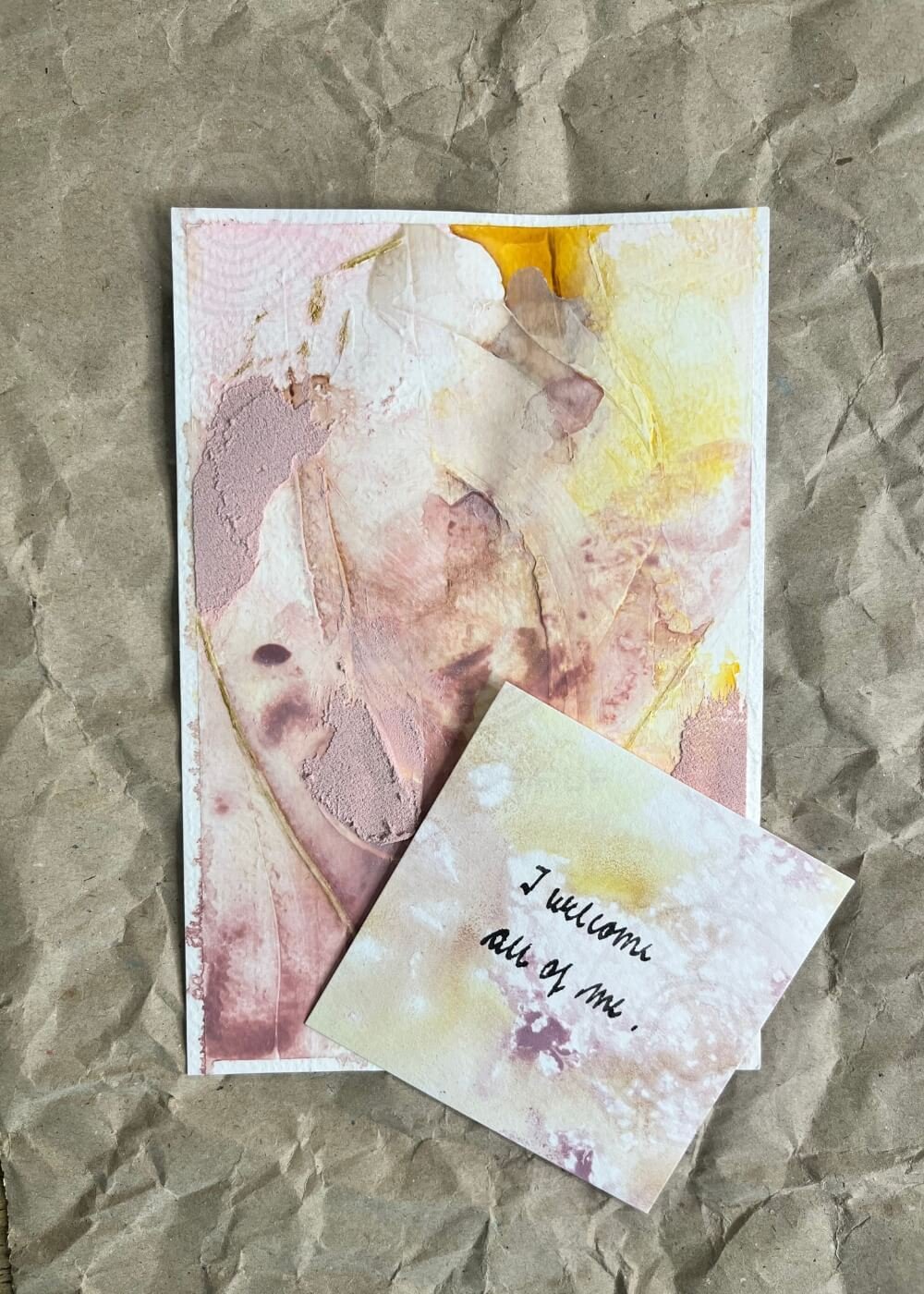 Postcard-sized mindfulness artwork “Held by Myself No. 6,” resting on kraft paper with an affirmation card affirming self-love and presence.