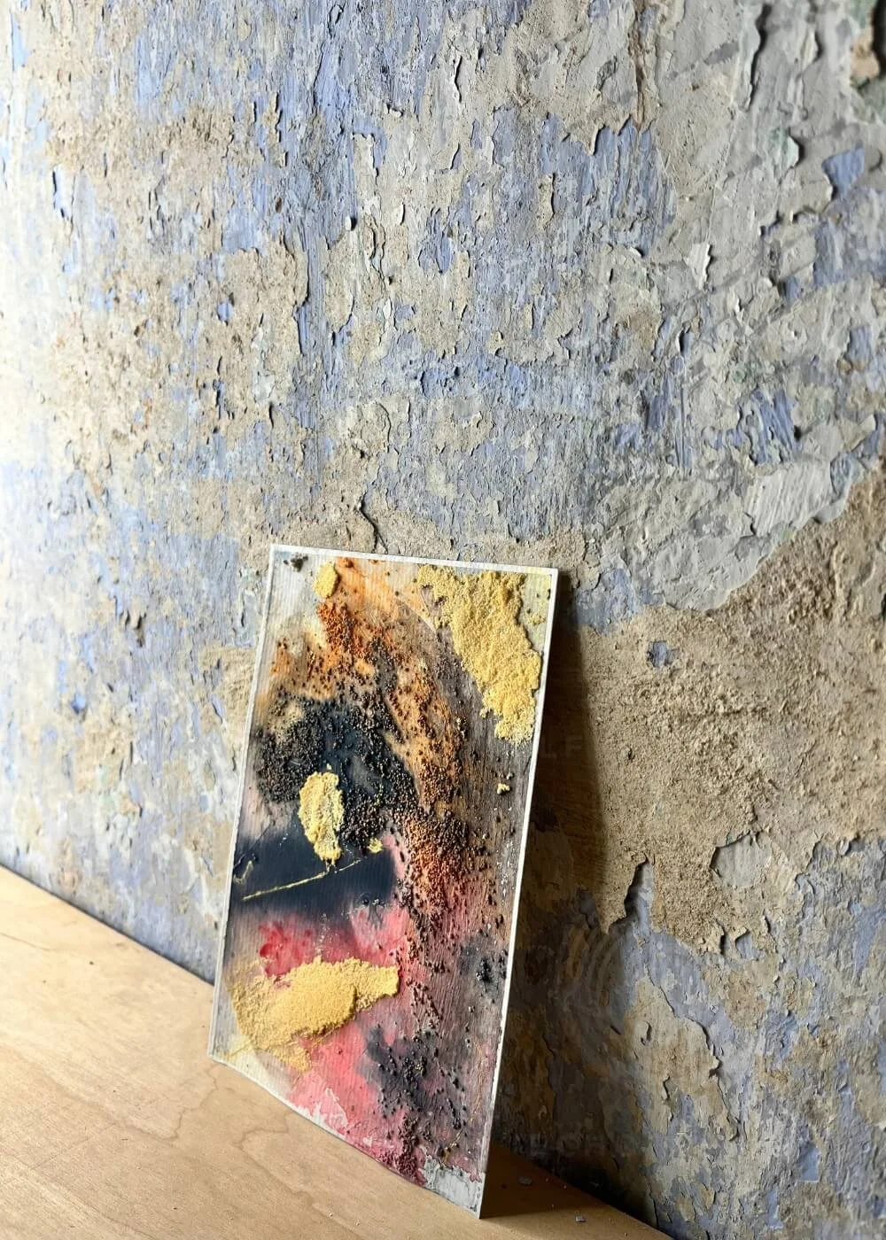 Side view of Ashes that still glow, revealing textured layers like cooling embers resting on ancient soil.