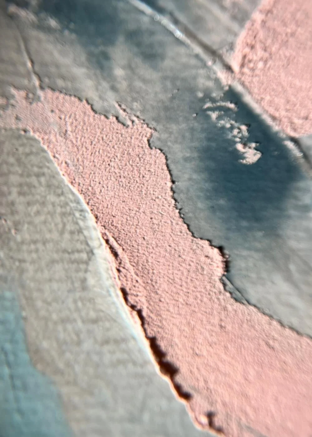 Macro view of rough blush texture meeting smooth blue surface, highlighting tactile depth and the quiet courage within tenderness.