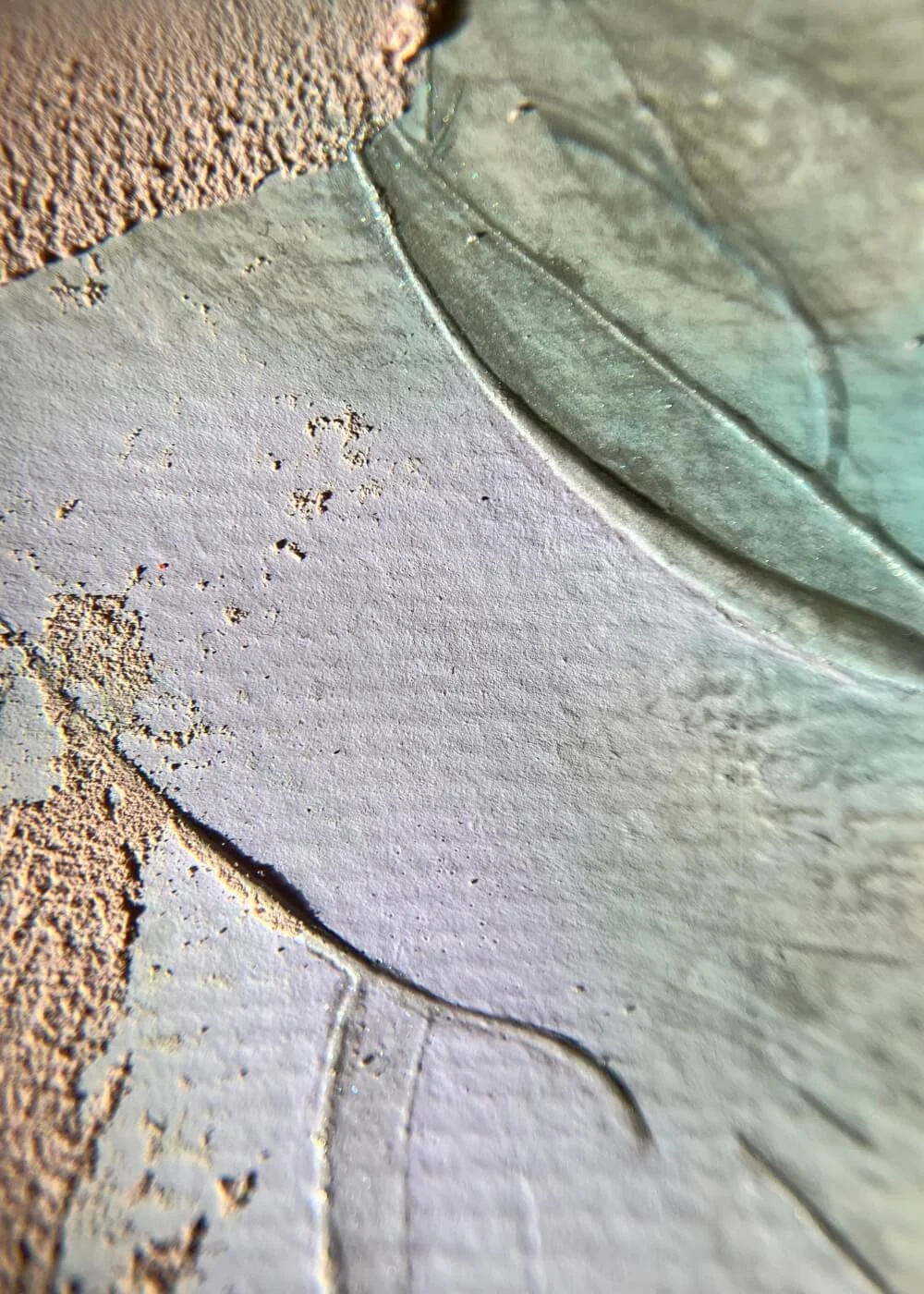 Detailed close-up of lilac and teal tones blending across textured plaster, illustrating calm motion and emotional transparency.