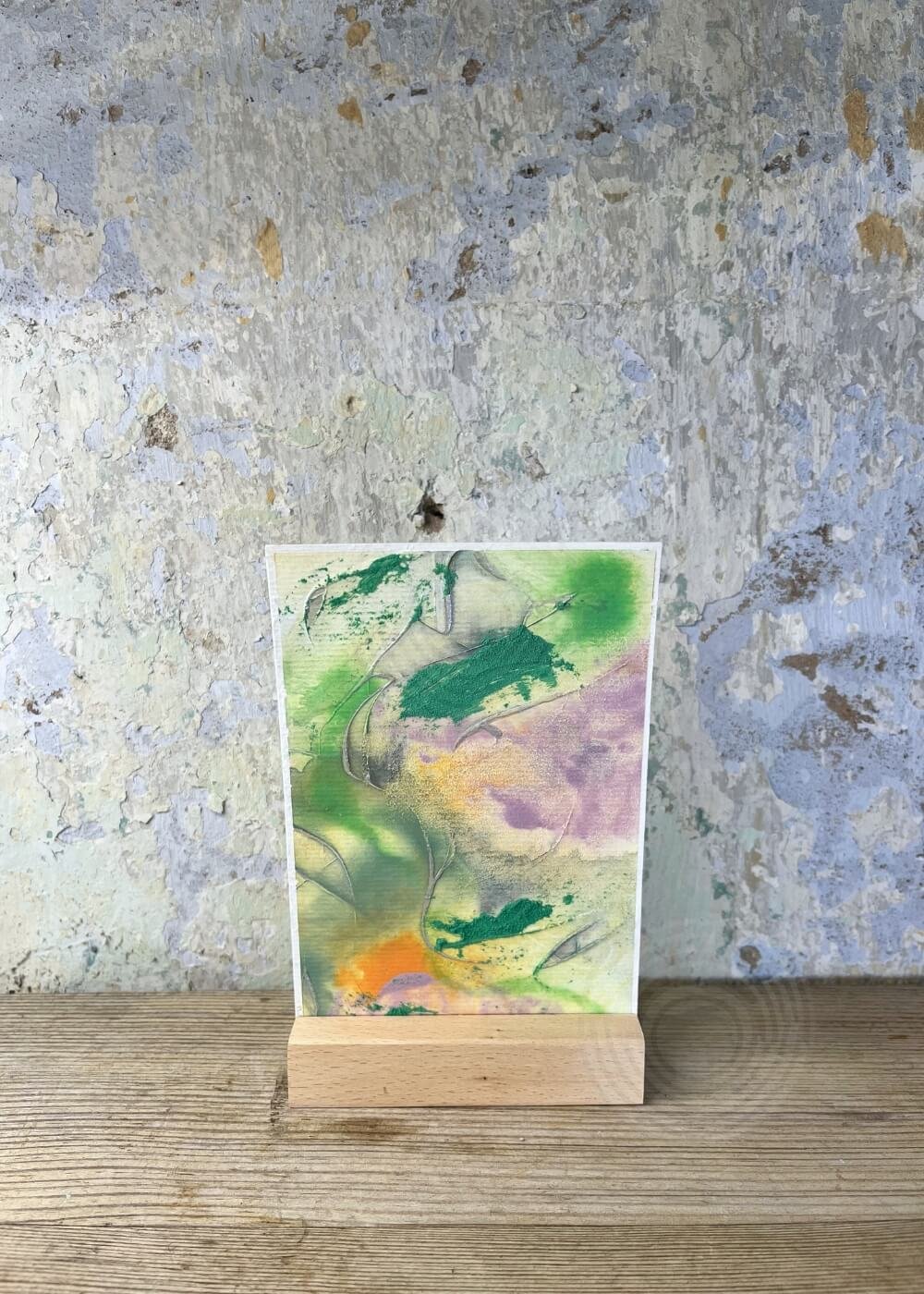 ‘Between the colors’ abstract artwork from the Silver Feathers Rising series – vivid green, orange, and violet layers with silver textures, symbolizing healing, release, and new beginnings.