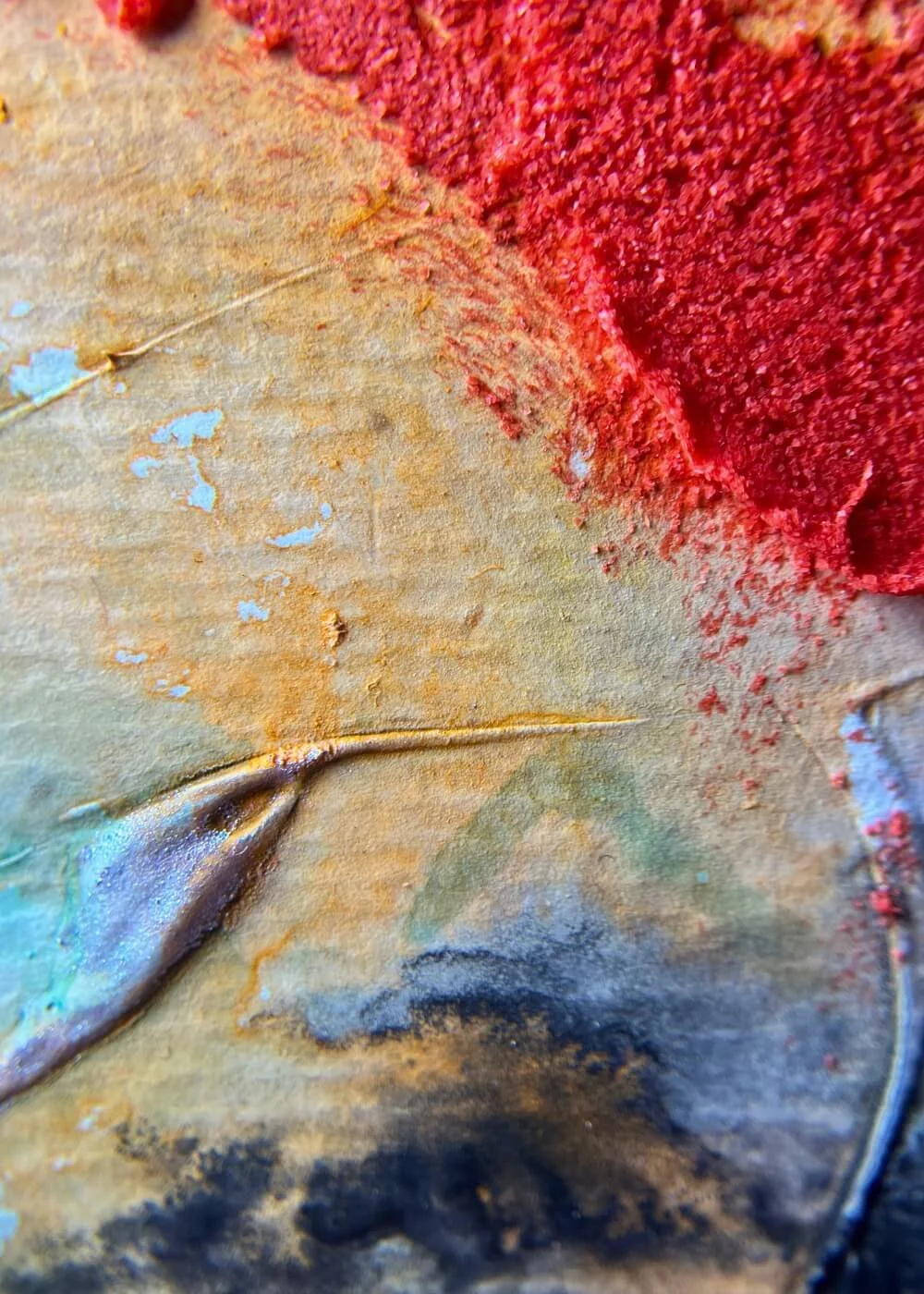 Close-up detail of textured abstract art Where I end and begin, showing layered pigments in ochre, red, and turquoise with fine embossed lines.