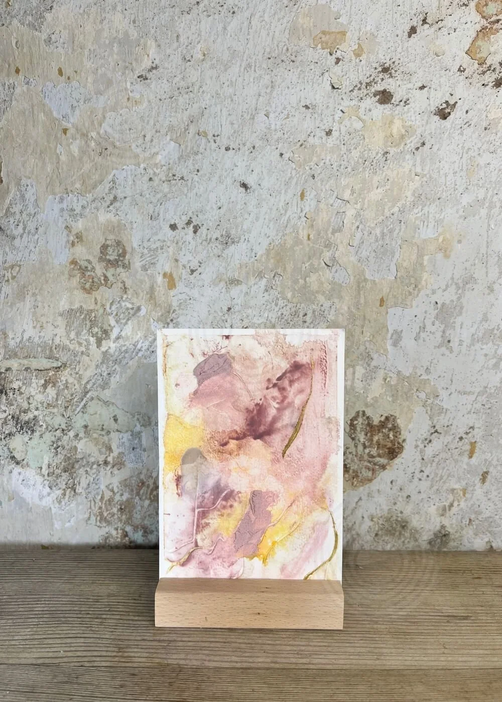 Healing tactile art piece “Held by Myself No. 5,” blending rose hues, luminous gold, and grounding textures on a postcard-sized paper.