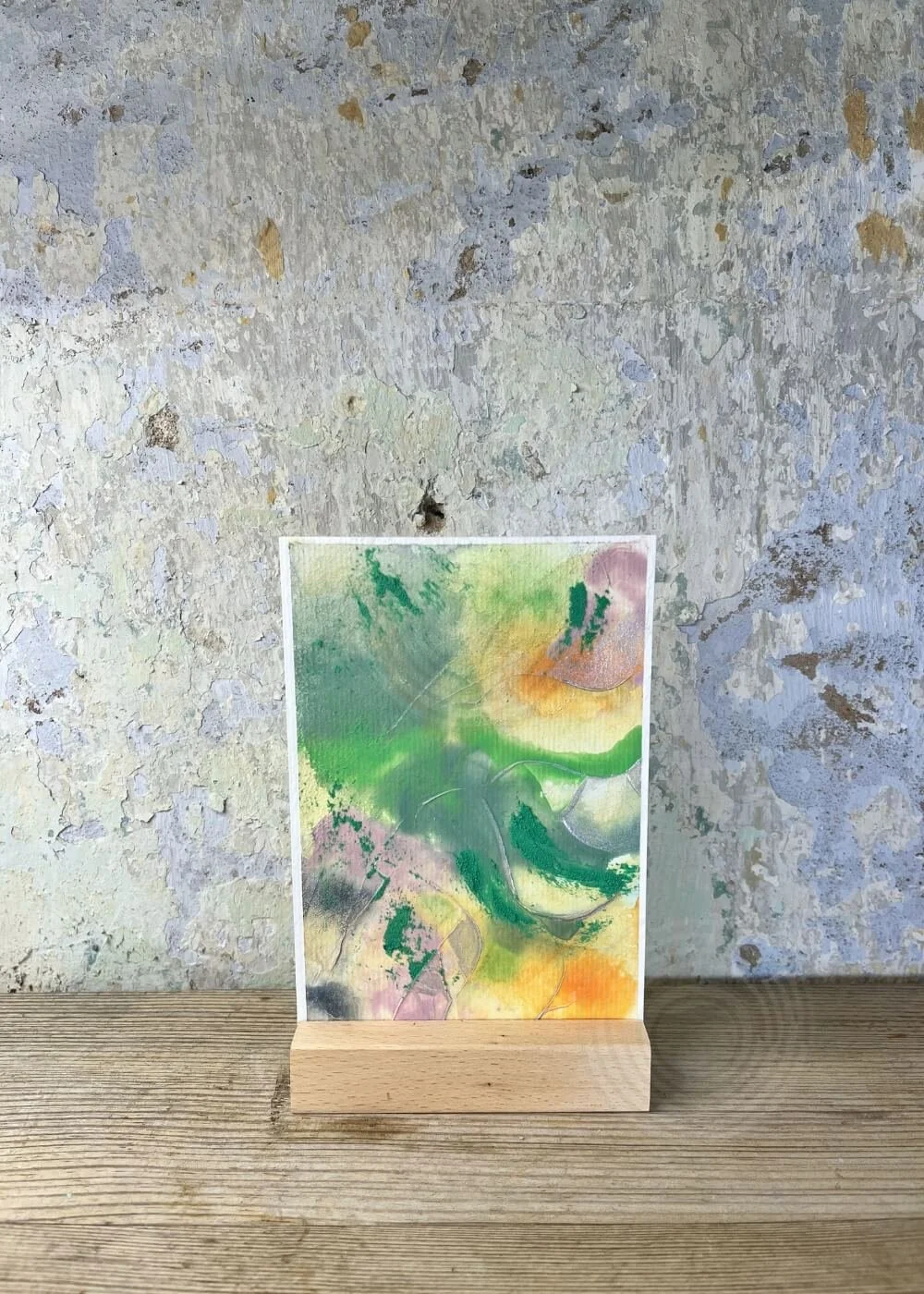 Abstract artwork I have arrived from the Silver Feathers Rising series, featuring soft green, orange, and violet layers symbolizing grounding and new beginnings.